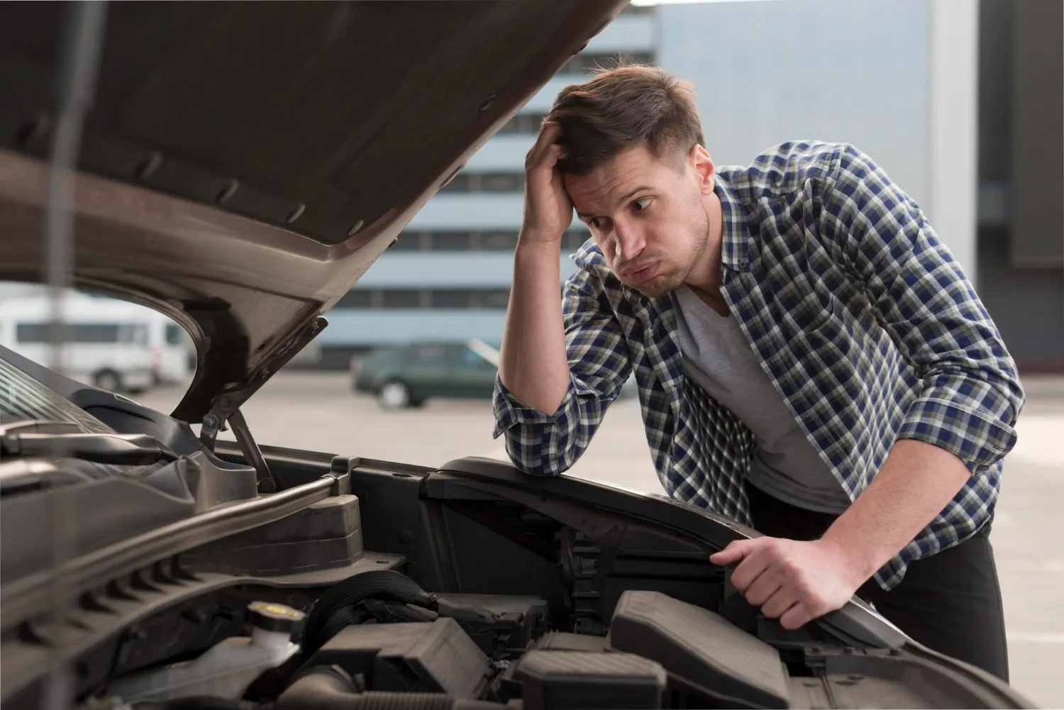 Young man with a car problem at Ethan’s Honest Automotive in Logan, Utah