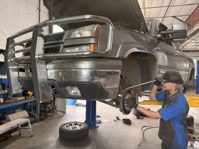 Shocks & Struts Repair & Suspension Services - Logan, UT 1 Technician performing suspension system inspection on a 2006 Chevrolet Silverado 1500 at Ethan’s Honest Automotive