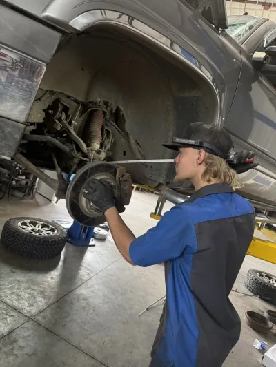 Shocks & Struts Repair & Suspension Services - Logan, UT 2 technician-inspecting-suspension-components-2006-chevrolet-silverado-1500-ethans-honest-automotive