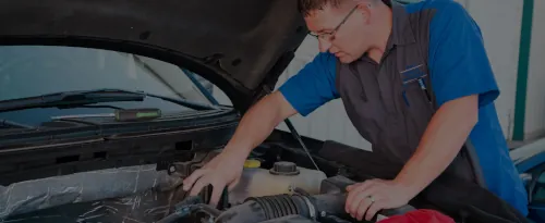 Master Mechanic Ethan from Ethan's Honest Automotive inspecting engine on a ford truck in North Logan, Utah